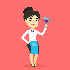 Image showing Bartender holding a glass of wine in hand.