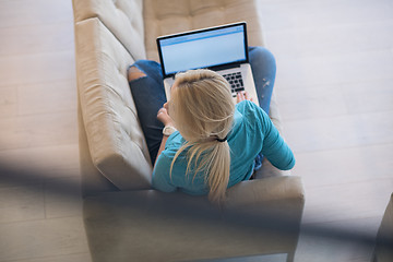 Image showing Young woman using laptop at home