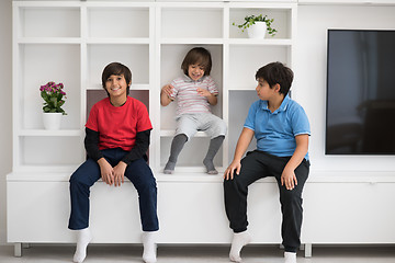 Image showing young boys posing on a shelf