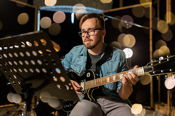 Image showing man playing guitar at studio rehearsal