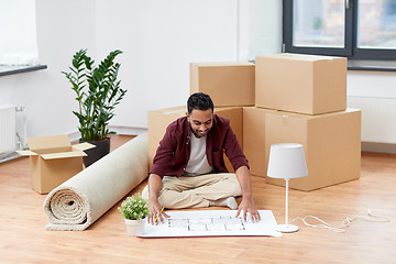 Image showing man with boxes and blueprint moving to new home