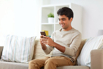 Image showing happy man with smartphone at home