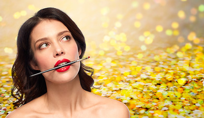 Image showing beautiful woman holding make up brush for lipstick