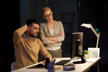 Image showing business team with computer working late at office