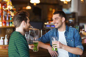 Image showing male friends drinking green beer at bar or pub