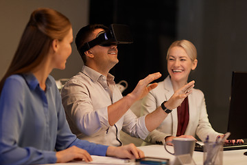 Image showing business team with computer working late at office