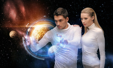 Image showing couple with planet hologram over space background