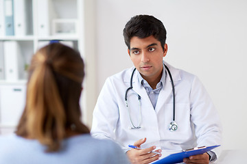 Image showing doctor with clipboard and patient at hospital