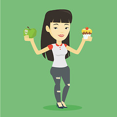 Image showing Woman choosing between apple and cupcake.