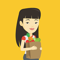 Image showing Happy woman holding grocery shopping bag.