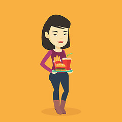 Image showing Woman holding tray full of fast food.