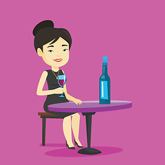 Image showing Woman drinking wine at restaurant.