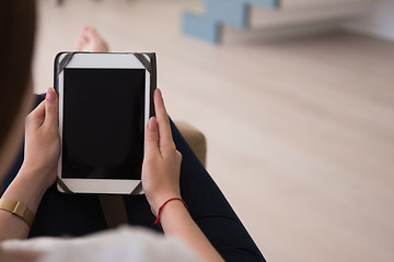 Image showing woman sitting on sofa with tablet computer