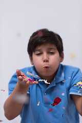 Image showing kid blowing confetti