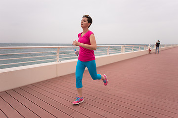 Image showing woman busy running on the promenade