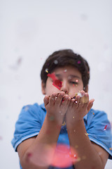 Image showing kid blowing confetti