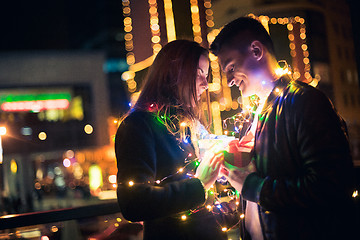 Image showing romantic surprise for Christmas, woman receives a gift from her boyfriend