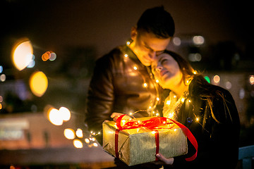 Image showing romantic surprise for Christmas, woman receives a gift from her 