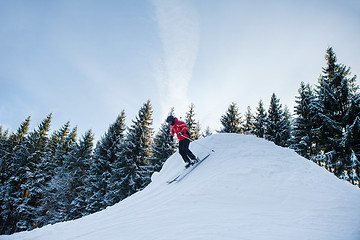 Image showing Full length shot of a woman skiing in the mountains