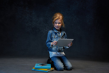 Image showing Little girl sitting with tablet