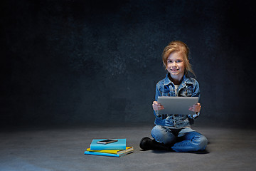 Image showing Little girl sitting with tablet
