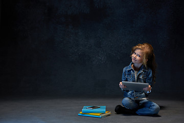 Image showing Little girl sitting with tablet