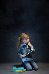 Image showing Little girl sitting with tablet