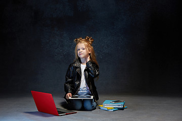 Image showing Little girl sitting with gadgets