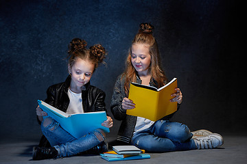 Image showing Two kids reading the books at studio
