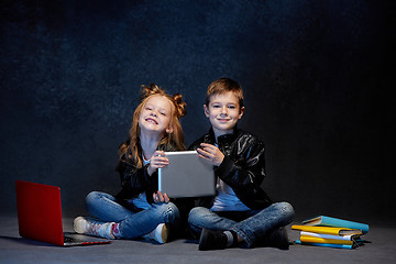 Image showing Studio shot of two children with laptop