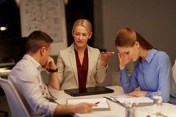 Image showing business team with laptop working late at office