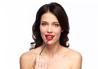 Image showing beautiful woman with make up brush for lipstick