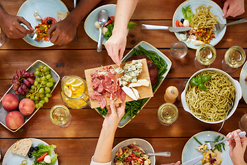 Image showing group of people eating at table with food