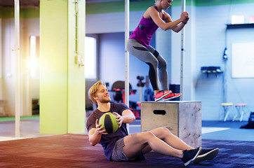 Image showing woman and man with medicine ball exercising in gym