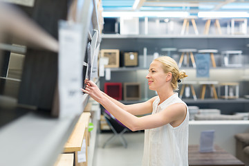 Image showing Beautiful young woman shopping in retail store.