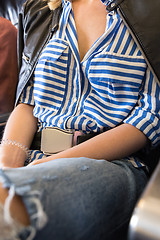 Image showing Female passenger with seat belt fastened while sitting on airplane for safe flight.