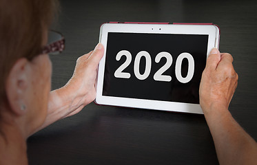 Image showing Senior lady relaxing and her tablet - 2020