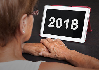 Image showing Senior lady relaxing and her tablet - 2018