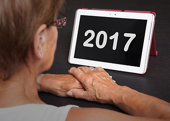 Image showing Senior lady relaxing and her tablet - 2017
