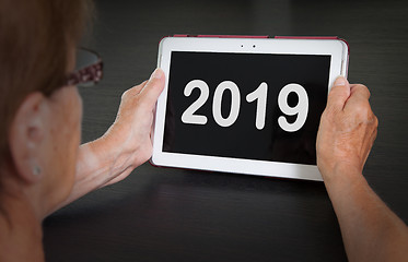 Image showing Senior lady relaxing and her tablet - 2019