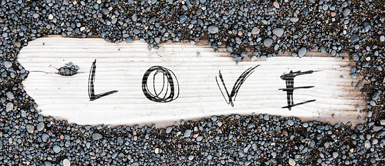 Image showing Sand on planked wood - Love