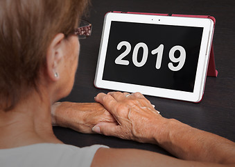 Image showing Senior lady relaxing and her tablet - 2019
