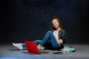 Image showing Little girl sitting with gadgets