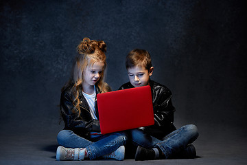 Image showing Studio shot of two children with laptop