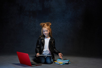Image showing Little girl sitting with gadgets
