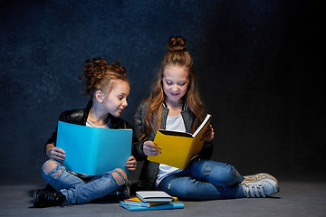 Image showing Two kids reading the books at studio