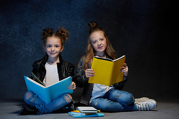 Image showing Two kids reading the books at studio