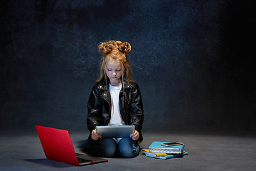 Image showing Little girl sitting with gadgets