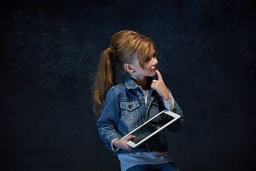 Image showing Little girl sitting with tablet