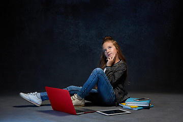 Image showing Little girl sitting with gadgets